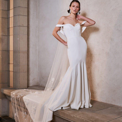 Off-the-shoulder, sweetheart neckline mermaid silhouette wedding dress.