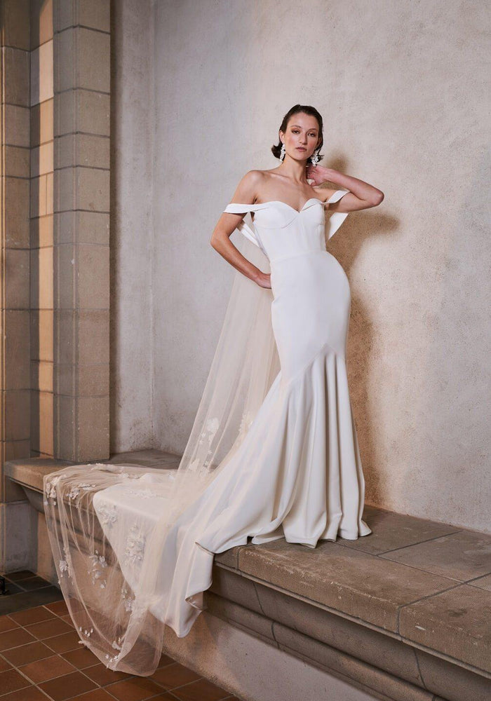 Off-the-shoulder, sweetheart neckline mermaid silhouette wedding dress.