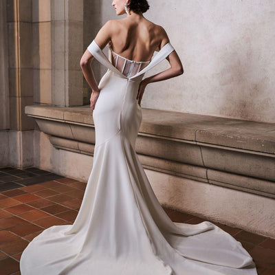 Off-the-shoulder, mesh open back mermaid silhouette wedding dress.
