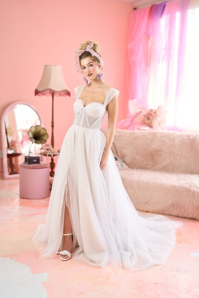 Model wearing Selma wedding dress with high slit from the Mademoiselle collection
