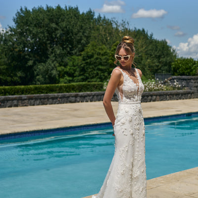 Fit-n-flare silhouette gown Taisha in ivory with 3D leafy applique. Plunging v-neckline with beaded waistbelt